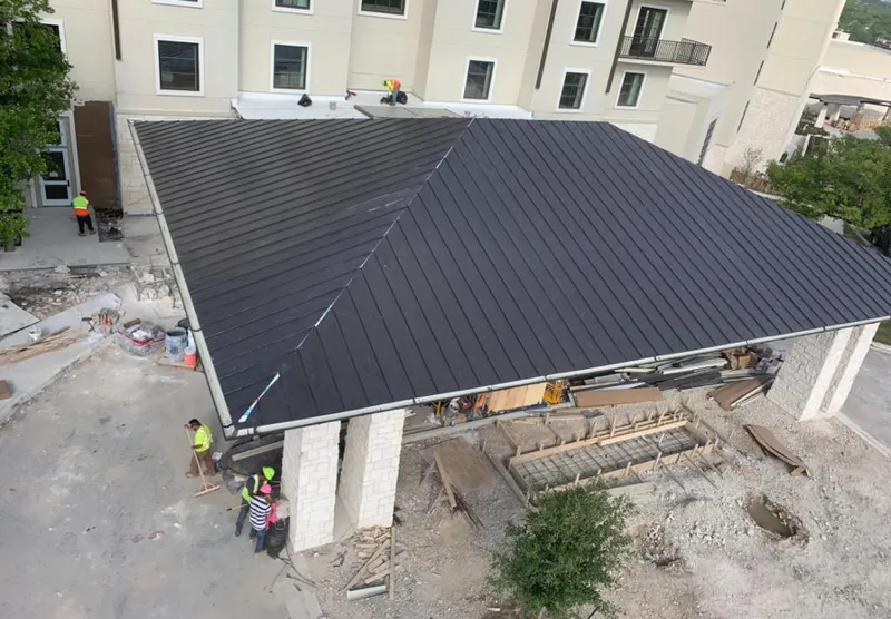 Metal roofing installation team working on a commercial building in Lebanon